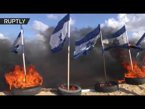 شاهد إحراق أعلام إسرائيل على حدود قطاع غزة